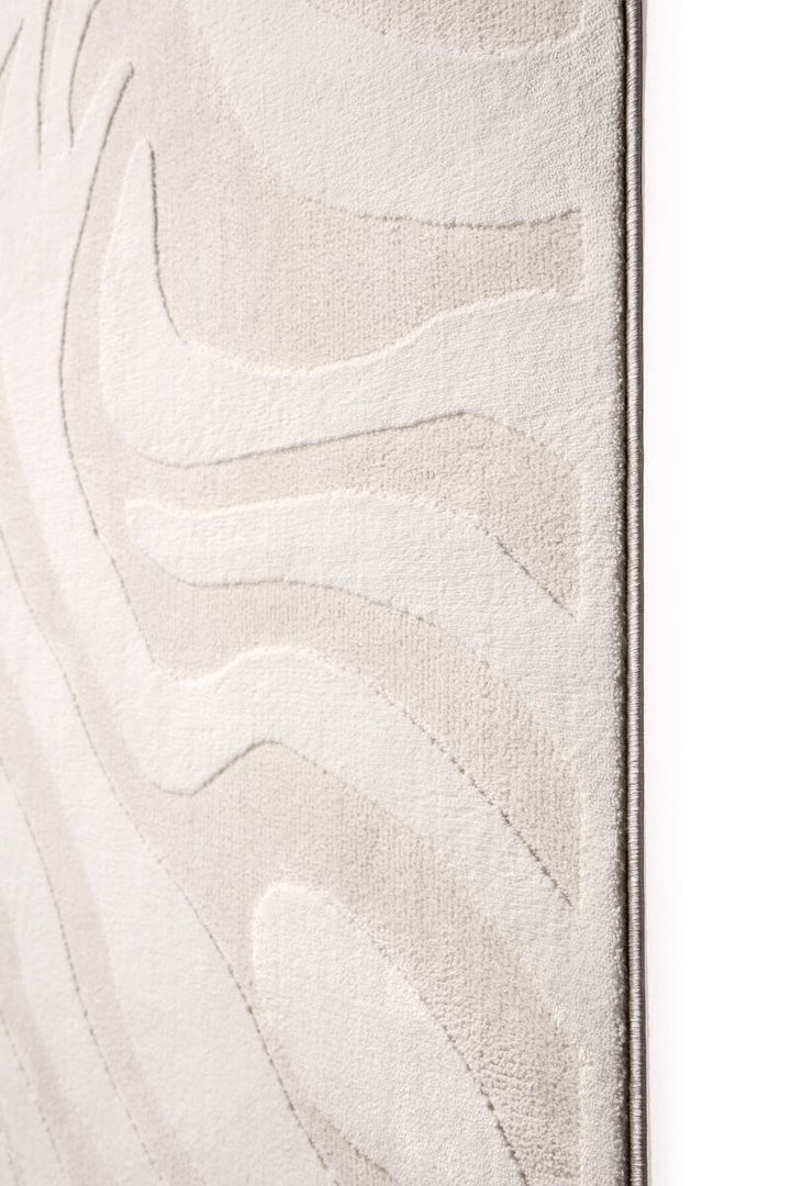 Abstract geometric rug in soft cream tones, showcasing textured patterns and modern design elements.