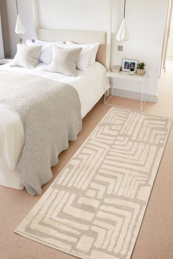 Ava Pave Wave Illusion Rug in cream abstract design enhancing a stylish bedroom with soft textures.
