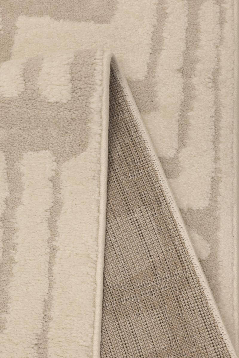 Close-up of the Ava Pave Wave Illusion Rug, showing its soft cream and abstract design with high-low pile texture.