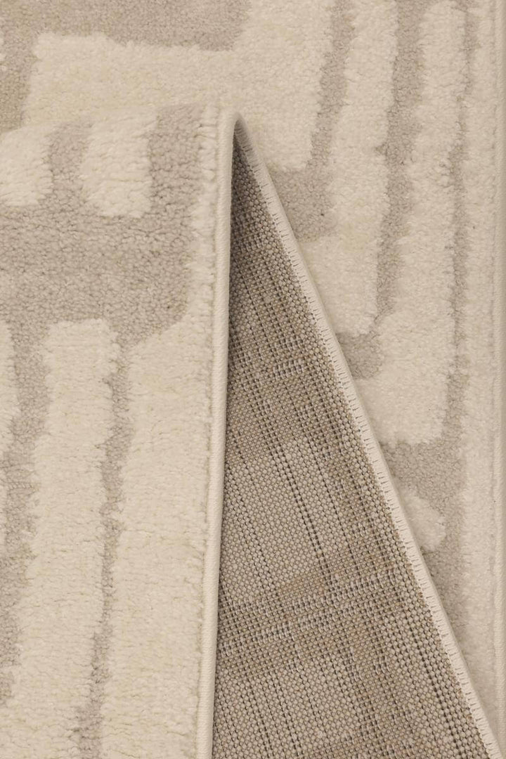 Close-up of the Ava Pave Wave Illusion Rug, showing its soft cream and abstract design with high-low pile texture.