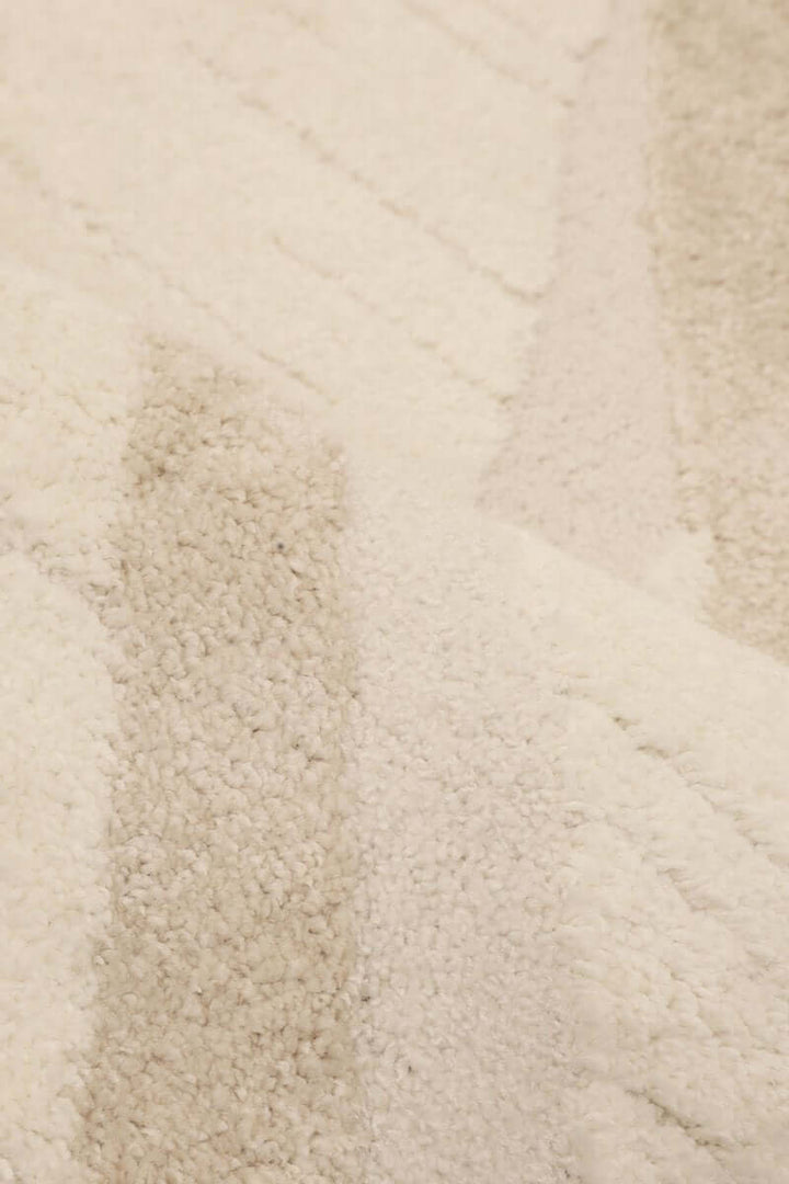 Ava Pave Wave Illusion Rug close-up, showcasing cream abstract design with high-low pile texture.