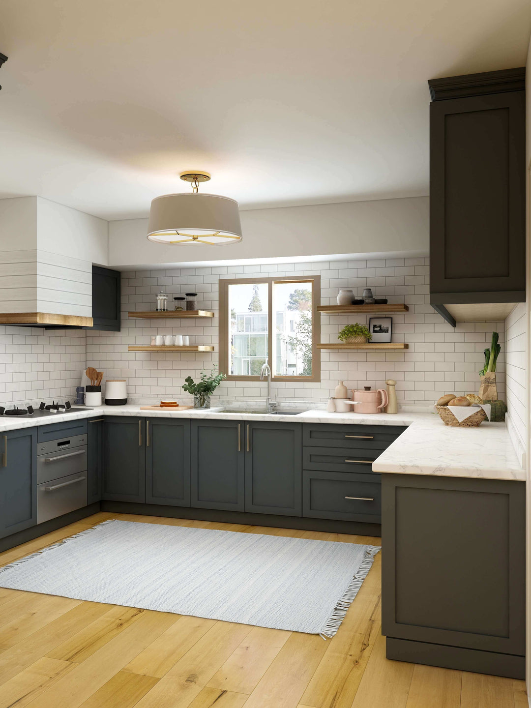 Modern kitchen interior featuring dark cabinets, white subway tile, marble countertops, and a pendant light.