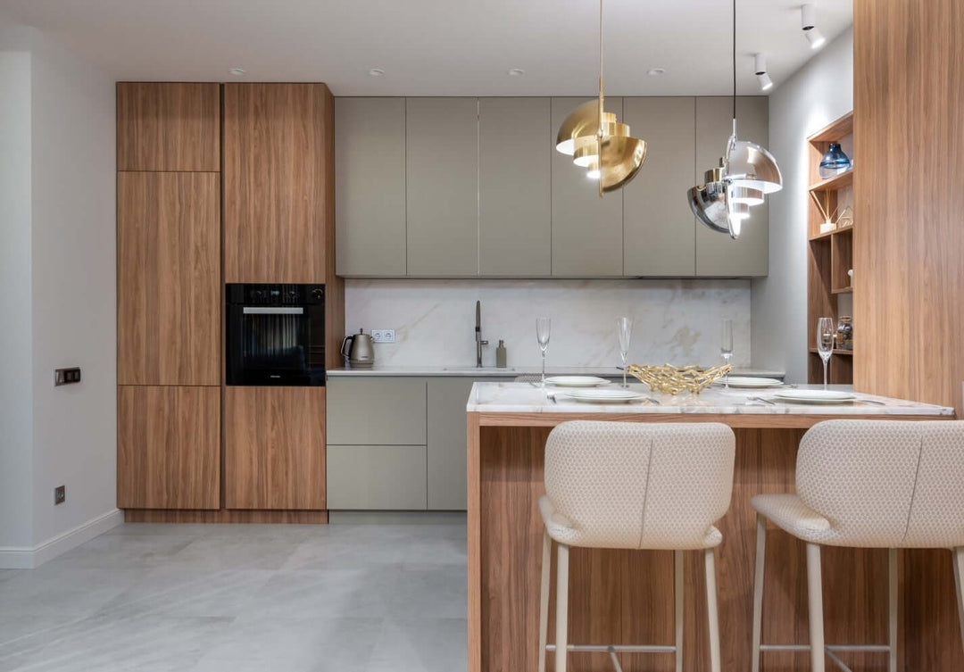 Modern kitchen design featuring wooden cabinetry, stylish lighting, and a sleek countertop.
