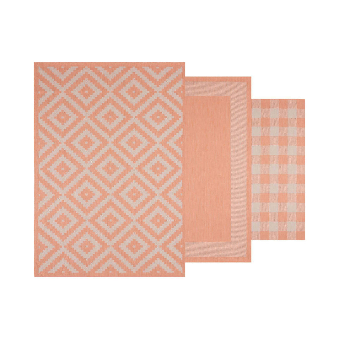 Three modern peach rugs featuring geometric patterns, including diamonds and checks, ideal for home decor.