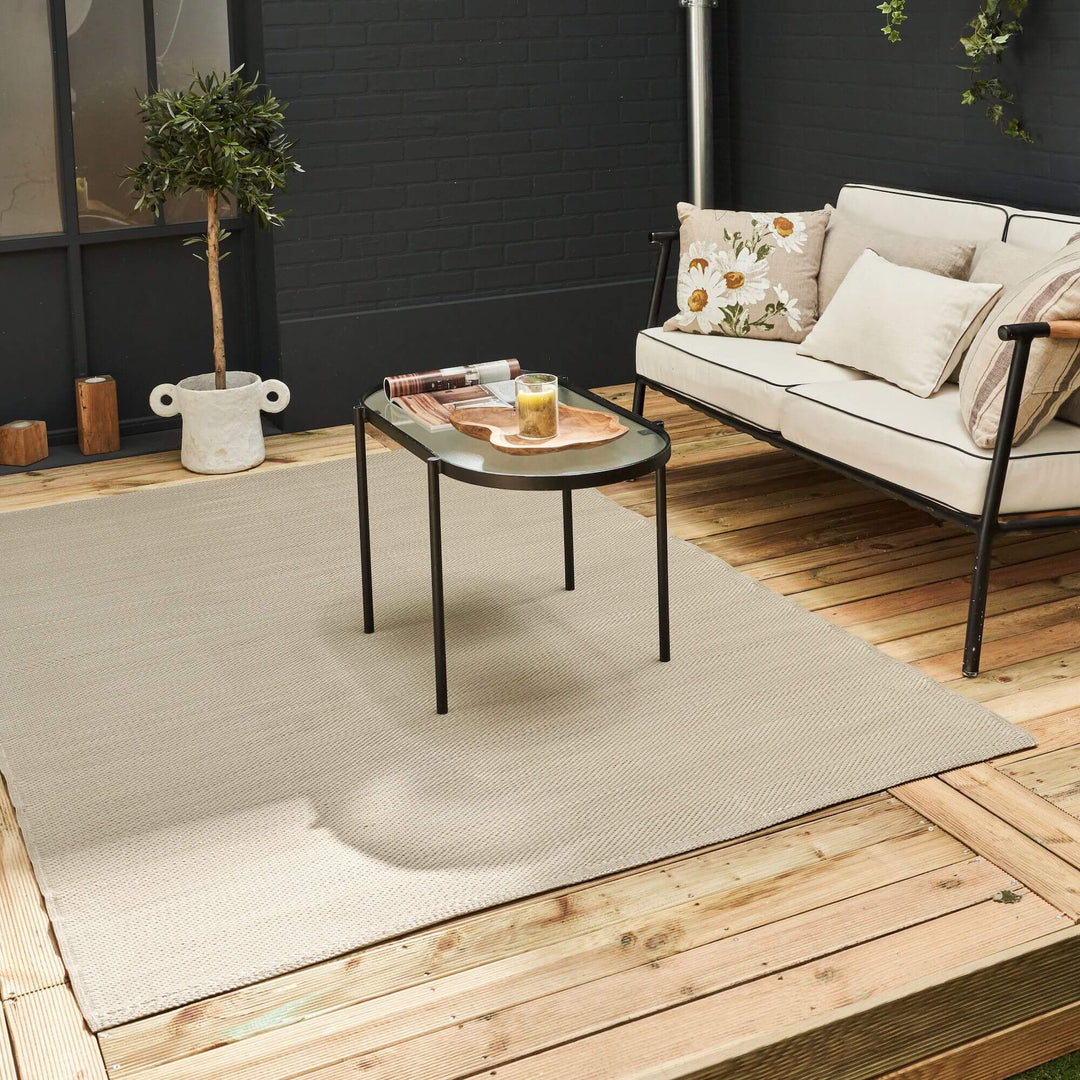 Beige urban outdoor rug with geometric design on a stylish patio setting, featuring modern decor and a cozy seating area.