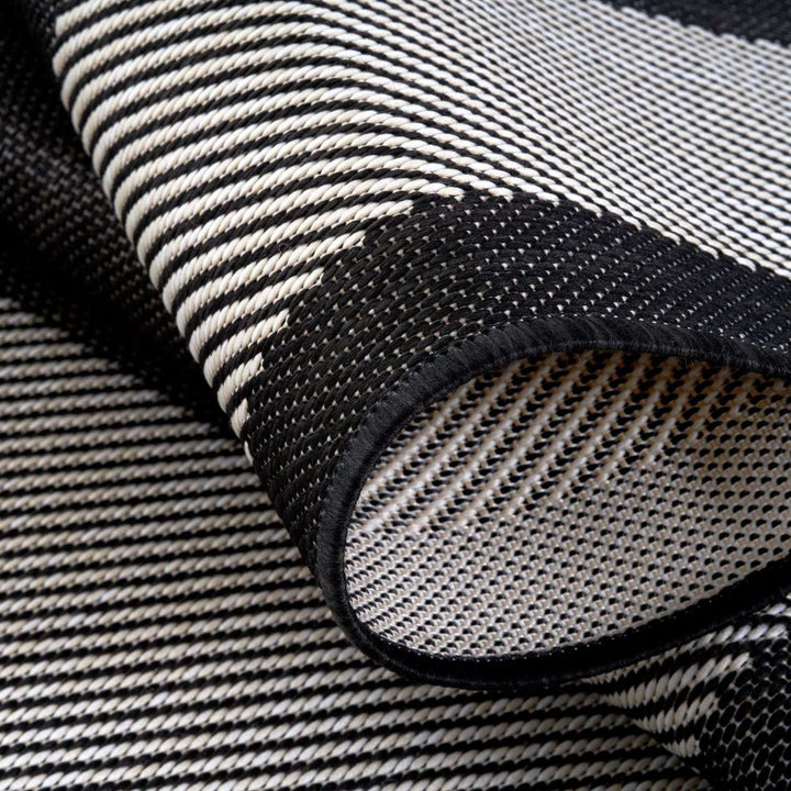 Outdoor Black Bordered Rug Weather resistant, Durable.