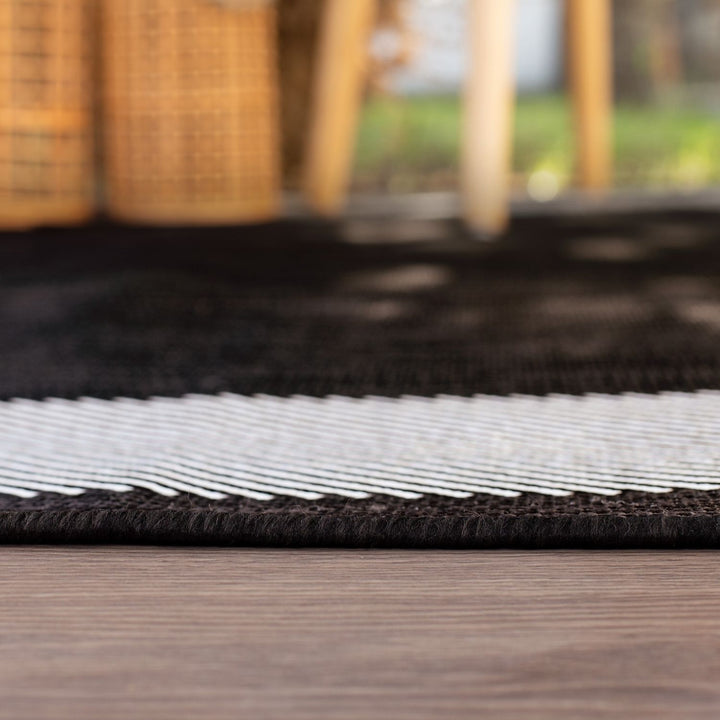 Outdoor Black Bordered Rug Weather resistant, Durable.