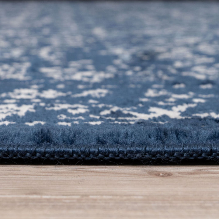 Close-up of a blue textured rug on a wooden floor