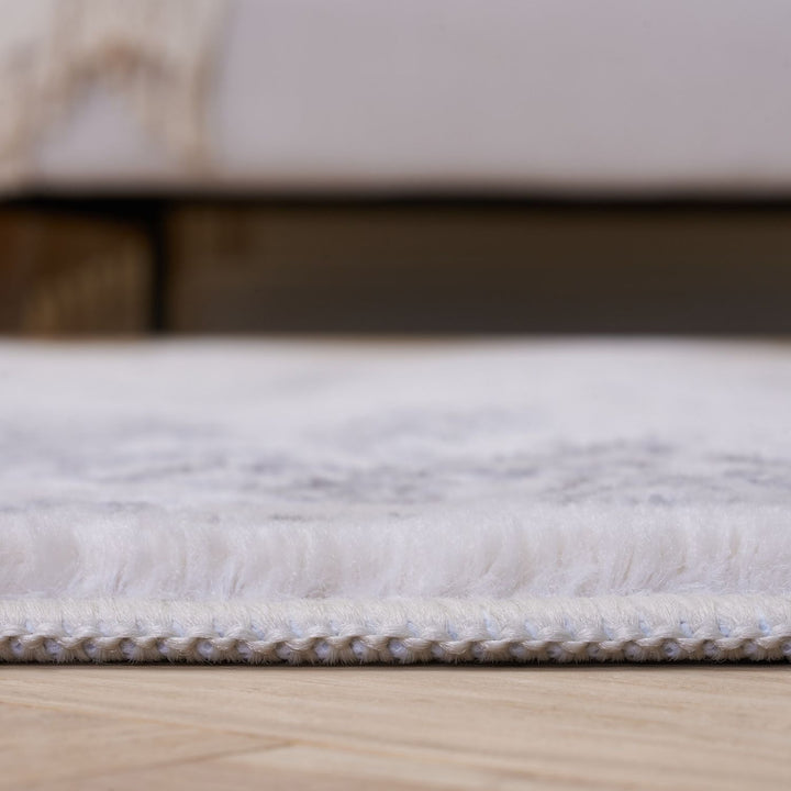Close-up of a textured white rug on a wooden floor