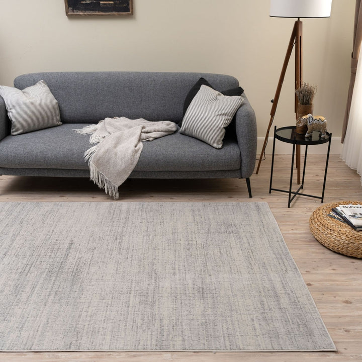 cream and grey rug features an abstract pattern