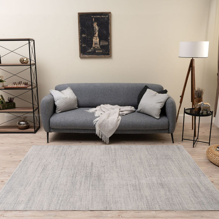 cream and grey rug features an abstract pattern