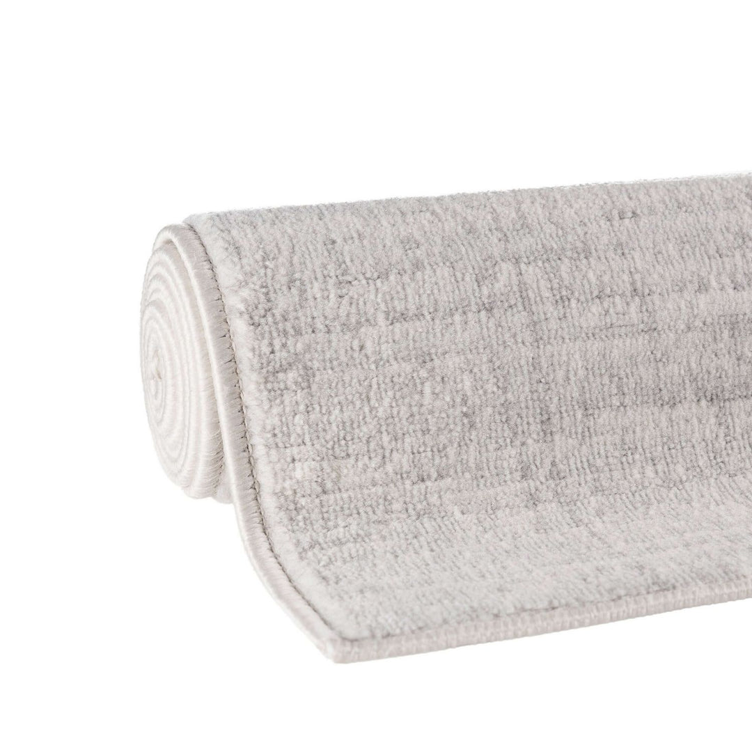 cream and grey rug features an abstract pattern