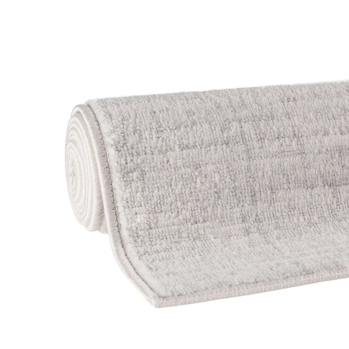 cream and grey rug features an abstract pattern