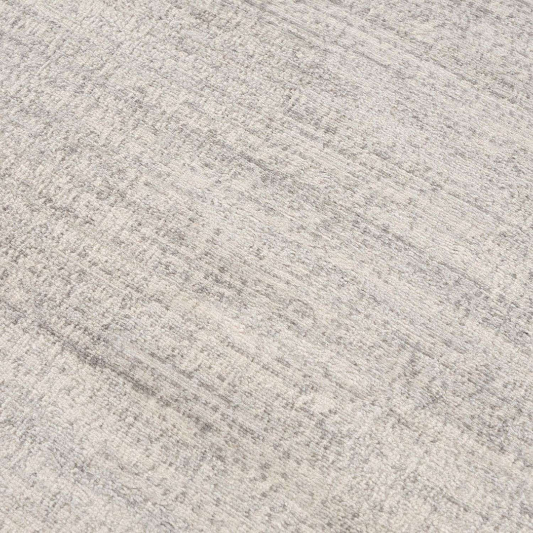 cream and grey rug features an abstract pattern