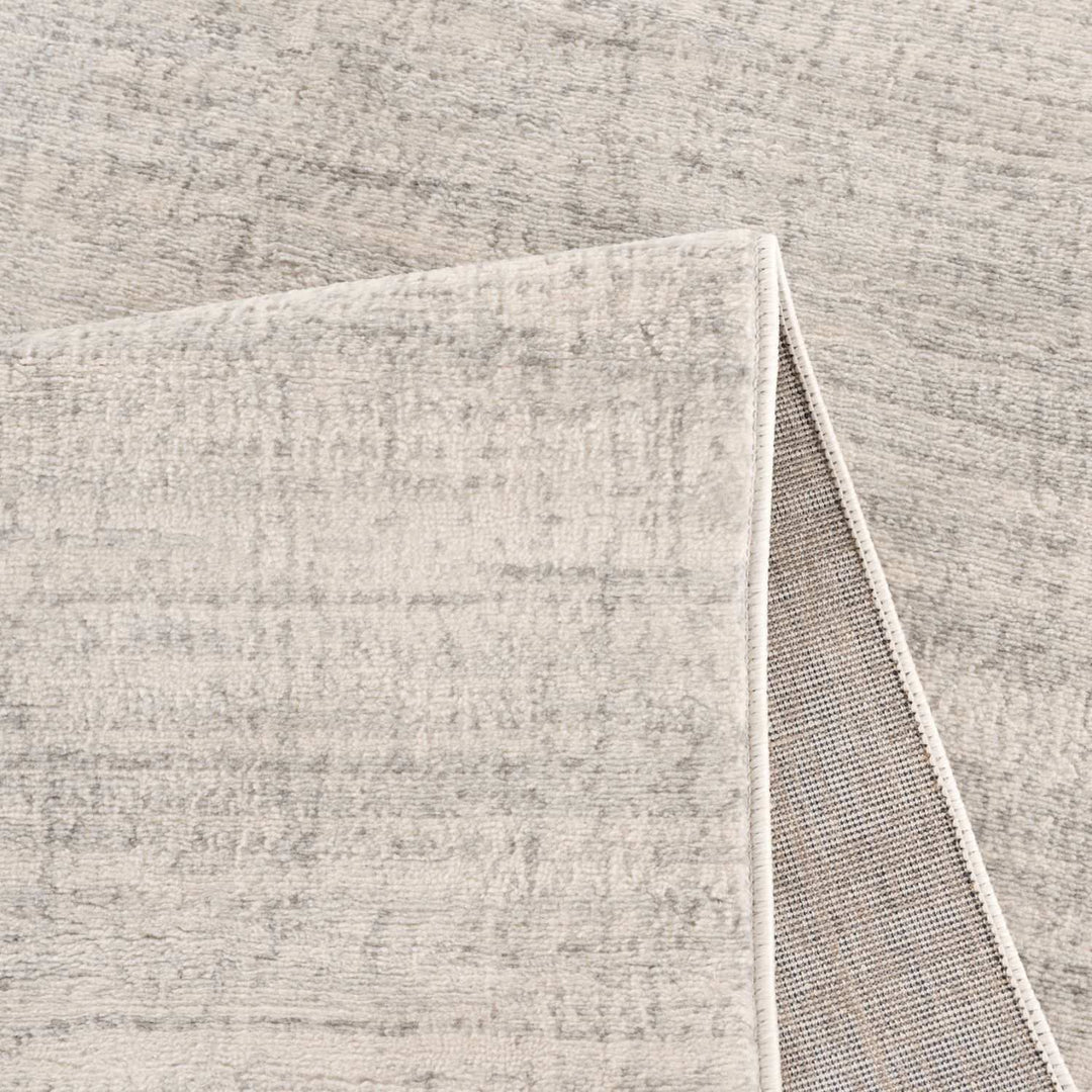 cream and grey rug features an abstract pattern
