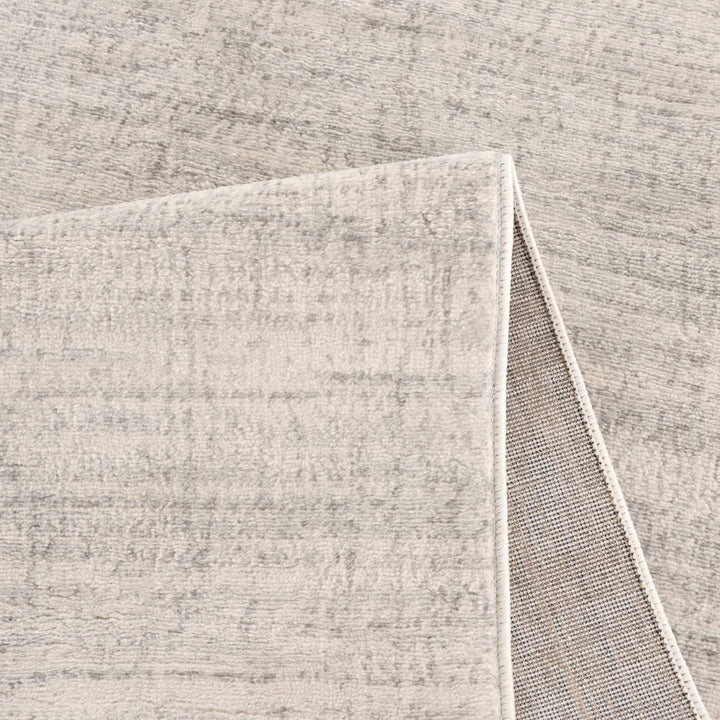 cream and grey rug features an abstract pattern