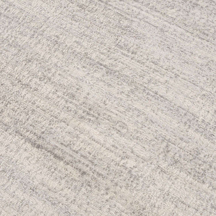 cream and grey rug features an abstract pattern