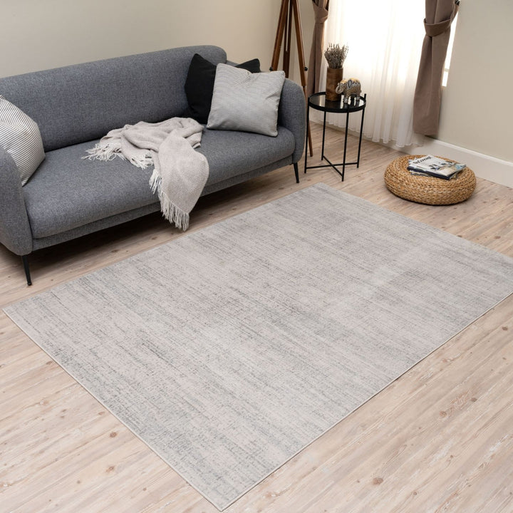 cream and grey rug features an abstract pattern