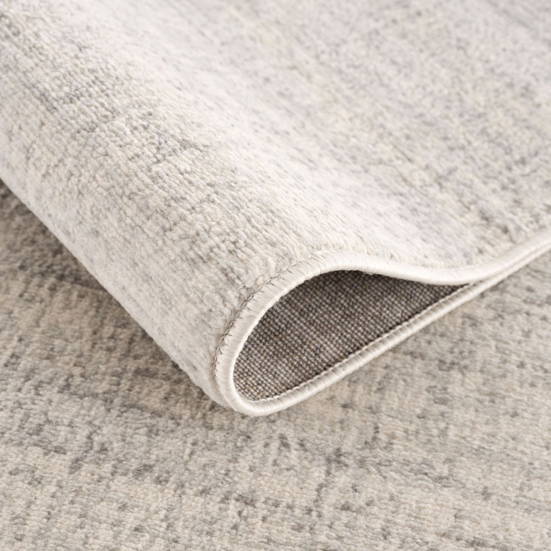 cream and grey rug features an abstract pattern