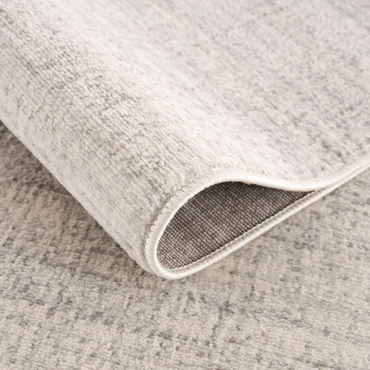 cream and grey rug features an abstract pattern