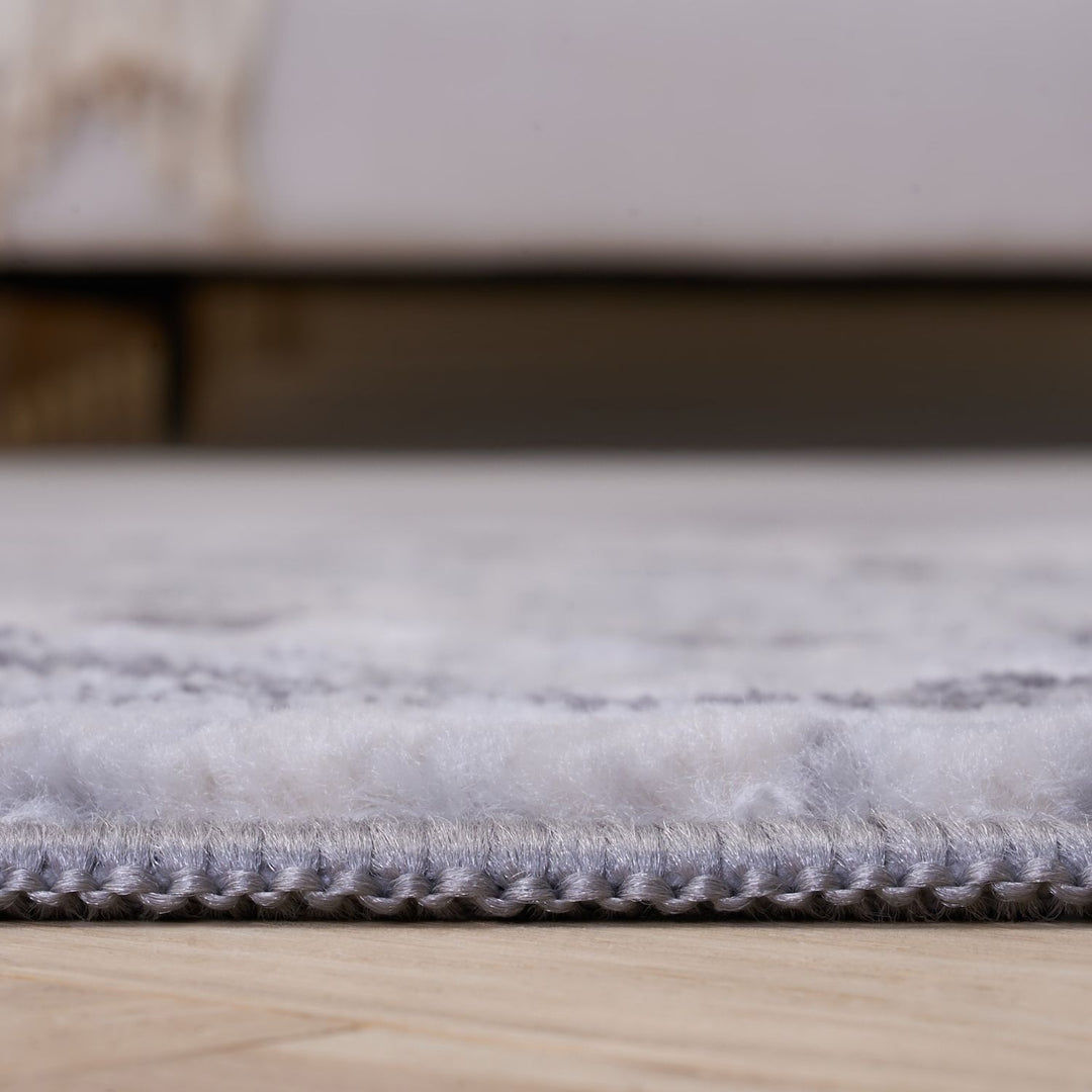 Close-up of a textured rug on a wooden floor