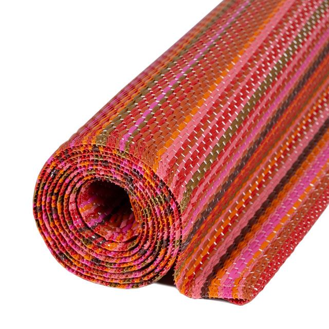 Vibrant striped geometric pattern Outdoor Rug in bold colors, rolled and ready to enhance any outdoor space with style.