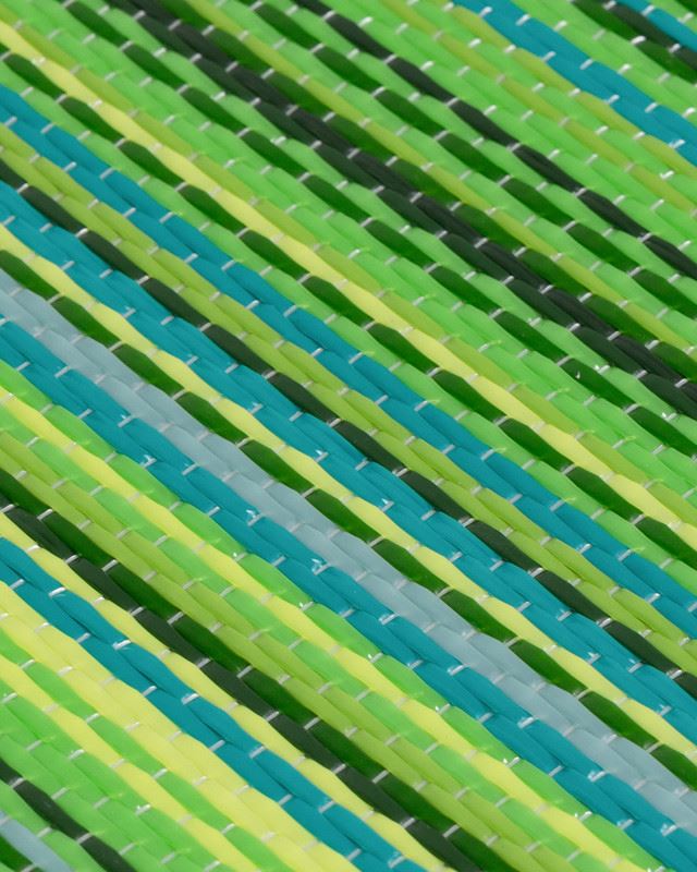 Green geometric pattern on Rainbow Outdoor Rug showing vibrant stripes for outdoor decor.