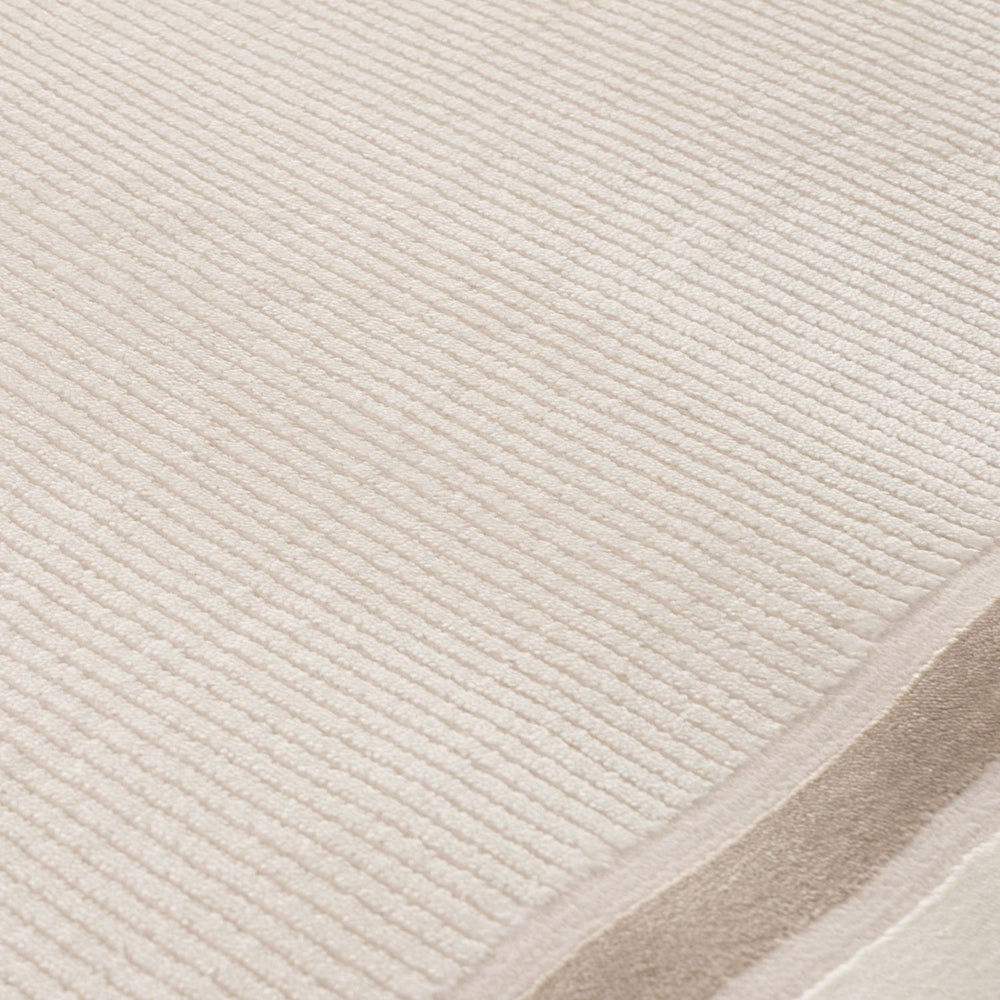 Close-up of a textured beige rug with a subtle pattern