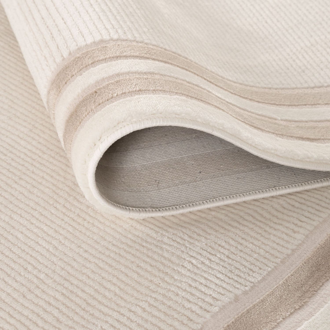 Close-up of a textured beige rug with wavy pattern