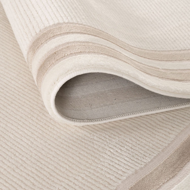 Close-up of a textured beige rug with wavy pattern