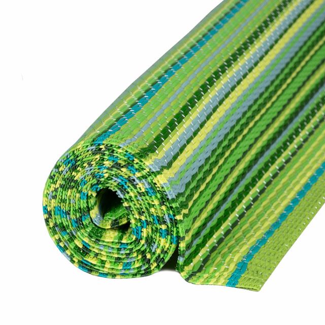 Green striped Rainbow Outdoor Rug rolled up for outdoor decor use.