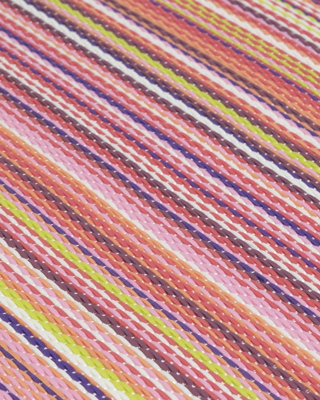 Vibrant striped geometric pattern on Rainbow Outdoor Rug in pink, showcasing colorful and bold design for outdoor decor.