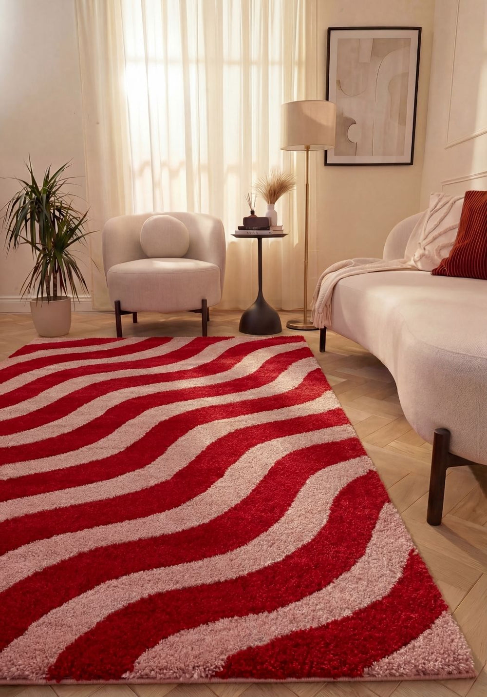 Living room with a red and pink striped rug, white armchair, and sofa.