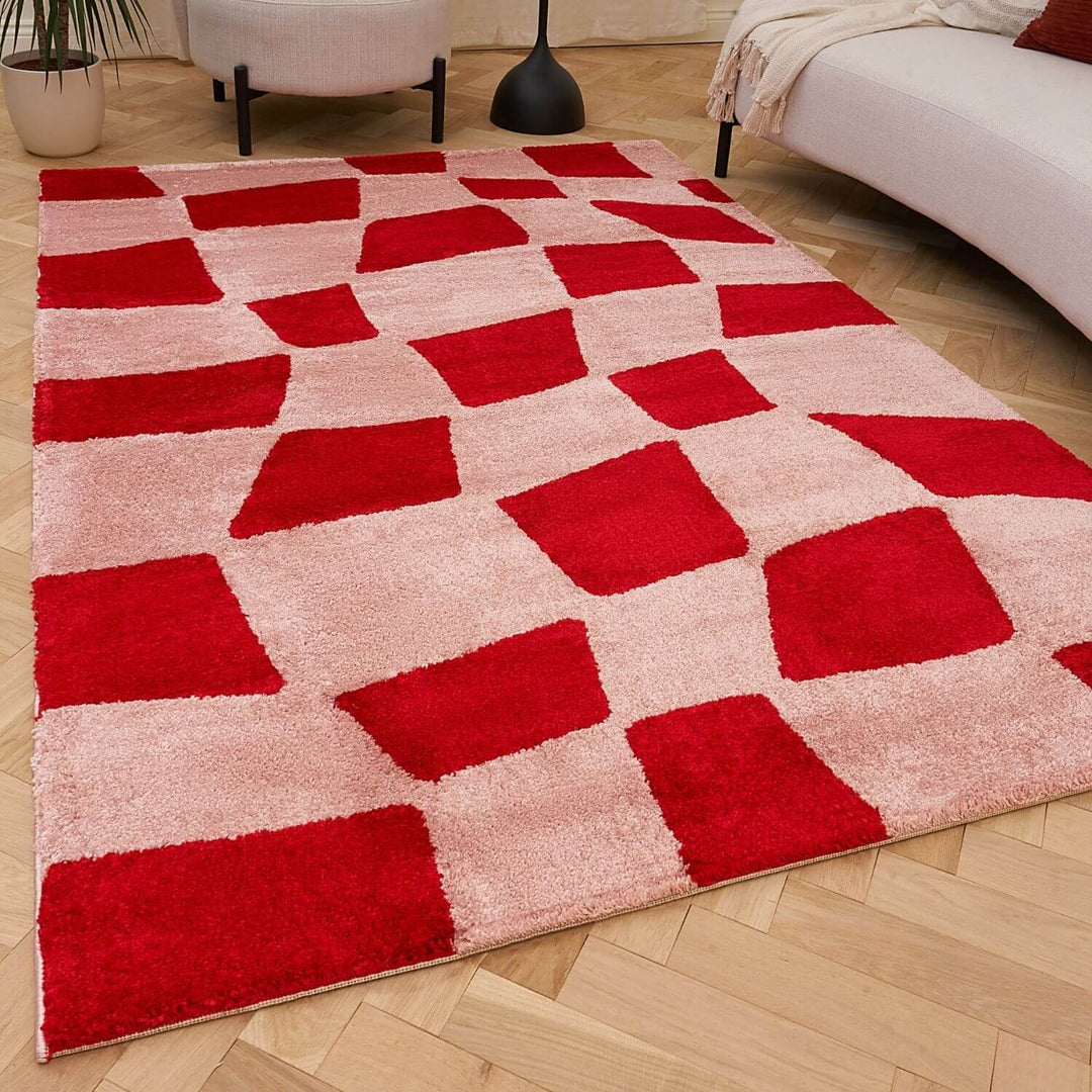 Red and beige checkered rug on a wooden floor