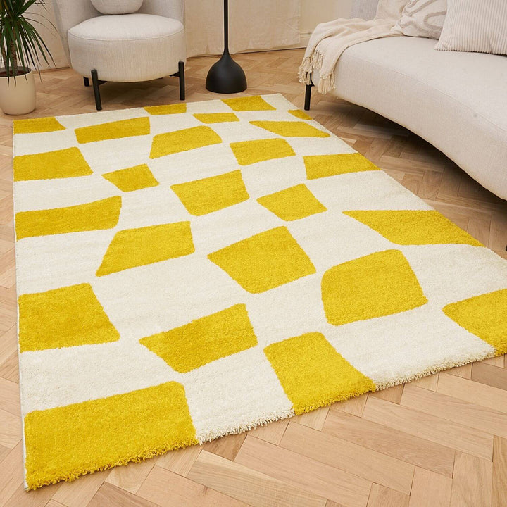 Yellow and white geometric patterned rug on a wooden floor
