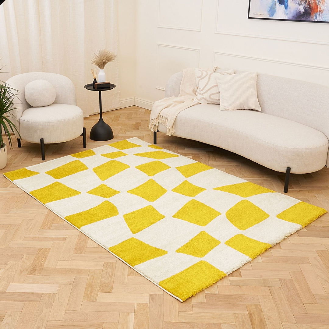 Living room with a yellow and white checkered rug, white sofa, and armchair.