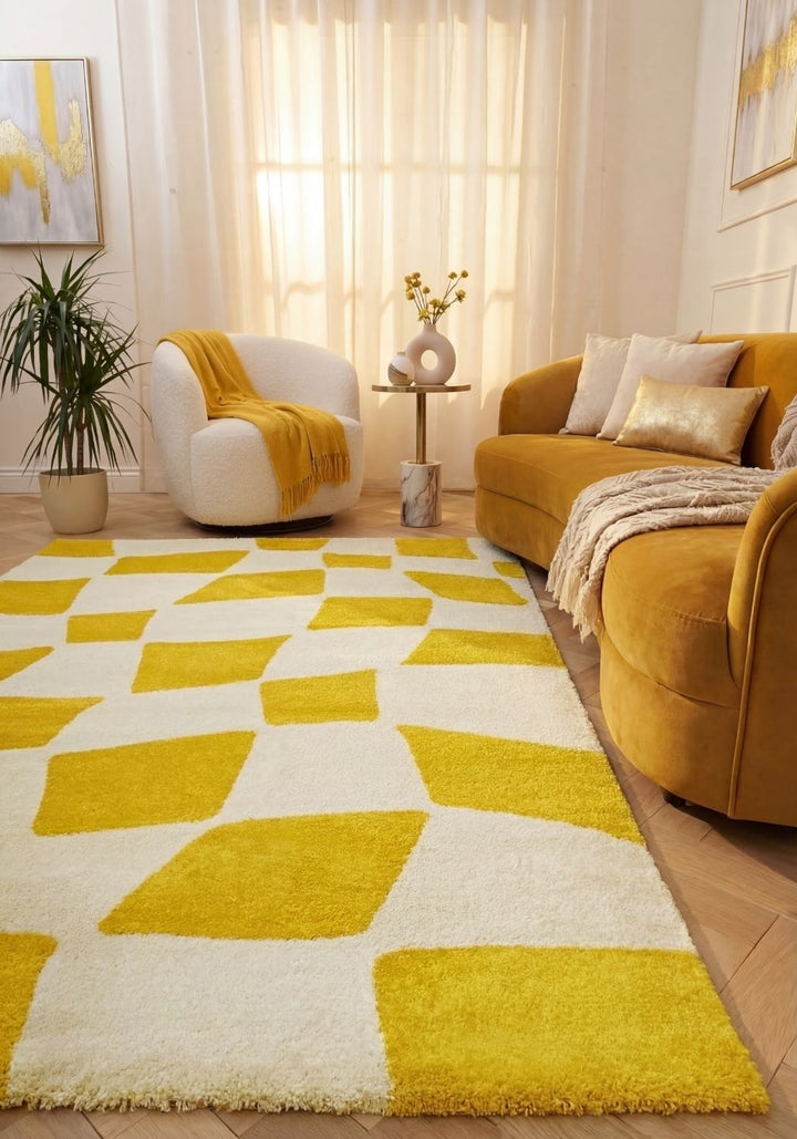 Living room with a yellow and white geometric rug, mustard-colored sofa, and white armchair.