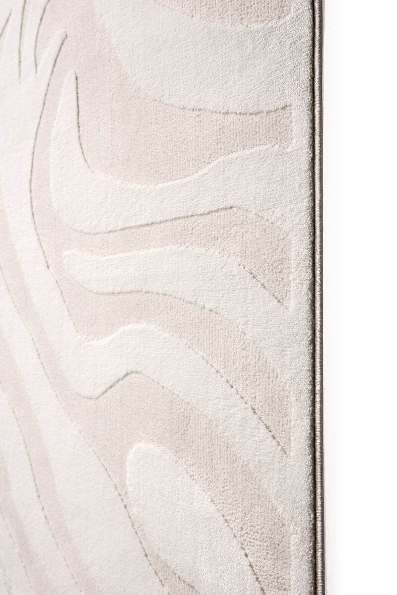 Abstract geometric rug in soft cream tones, showcasing textured patterns and modern design elements.