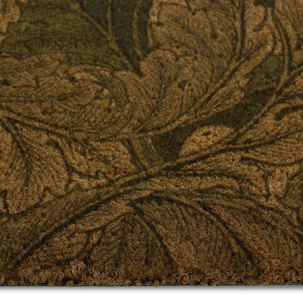Close-up of a textured brown doormat with leaf patterns