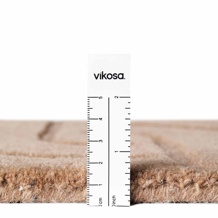 Measurement of vikosa carpet fibers with a ruler showing thickness.