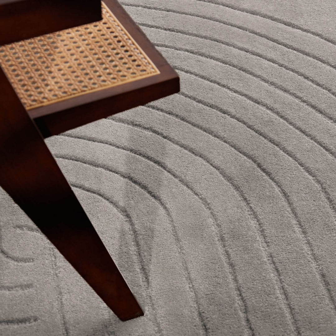 Gray textured carpet with a wooden step stool