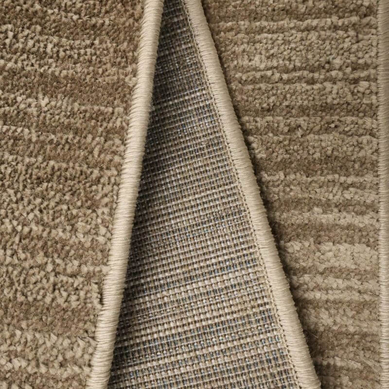 Close-up of the Arlo Textured Rug showcasing its soft pile and durable backing in a neutral brown tone.