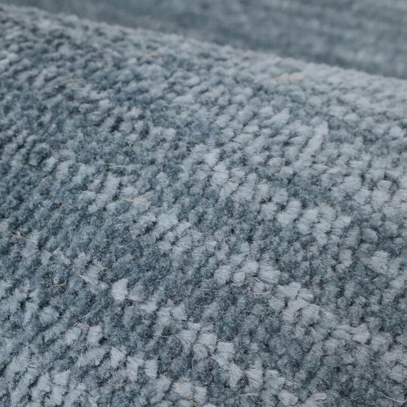 Close-up of the Arlo Textured Rug in soft blue tones, showcasing its luxurious 10mm pile and intricate stripe pattern.