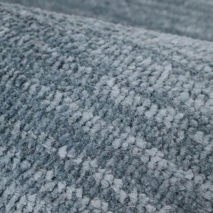 Close-up of the Arlo Textured Rug in soft blue tones, showcasing its luxurious 10mm pile and intricate stripe pattern.