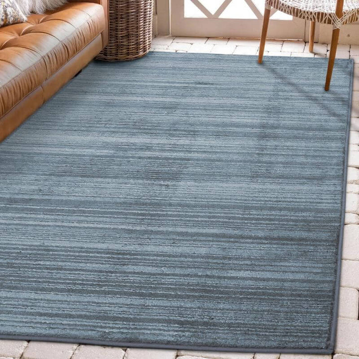 Arlo Textured Rug in soft blue tone, featuring subtle stripes, enhancing interior sophistication and comfort.