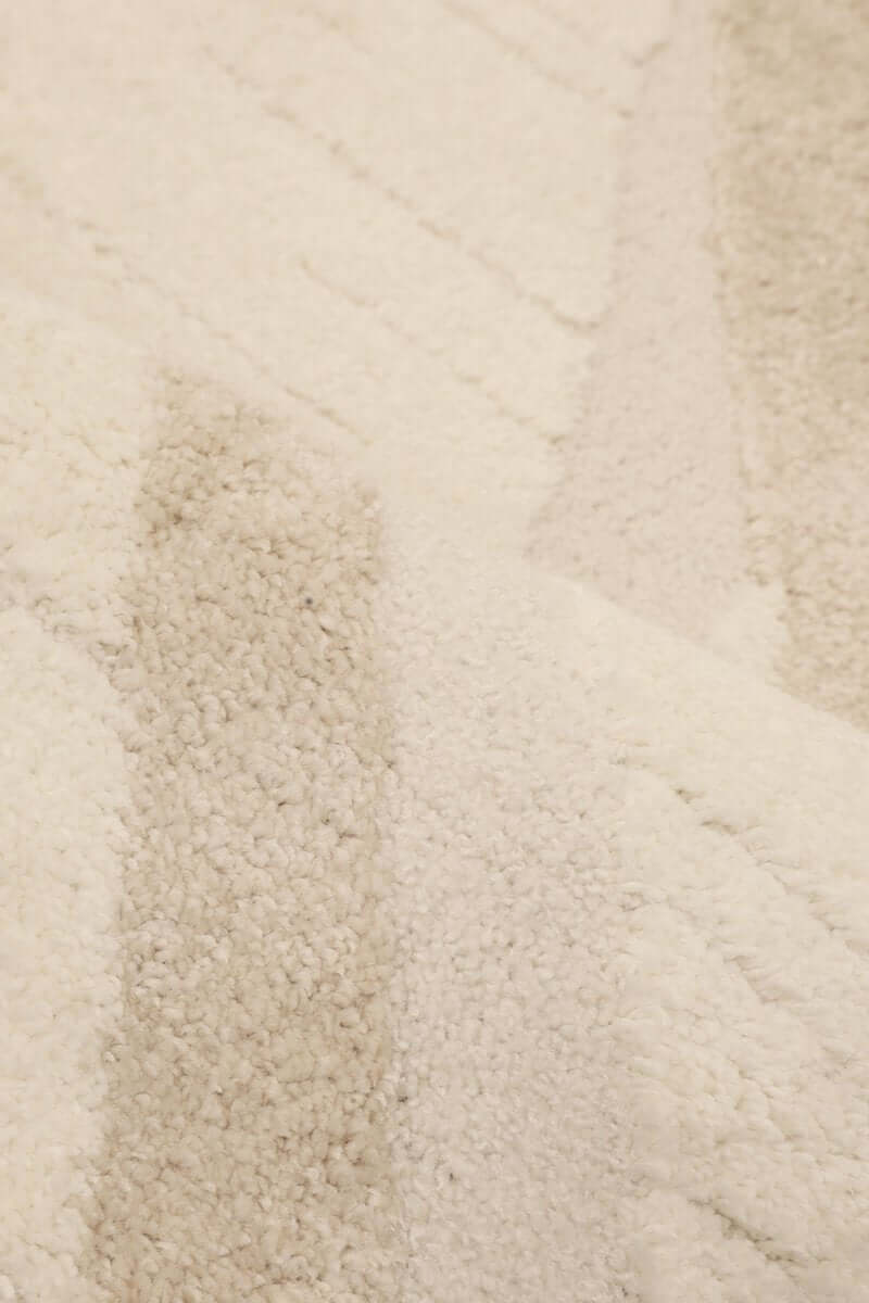Ava Pave Wave Illusion Rug close-up, showcasing cream abstract design with high-low pile texture.