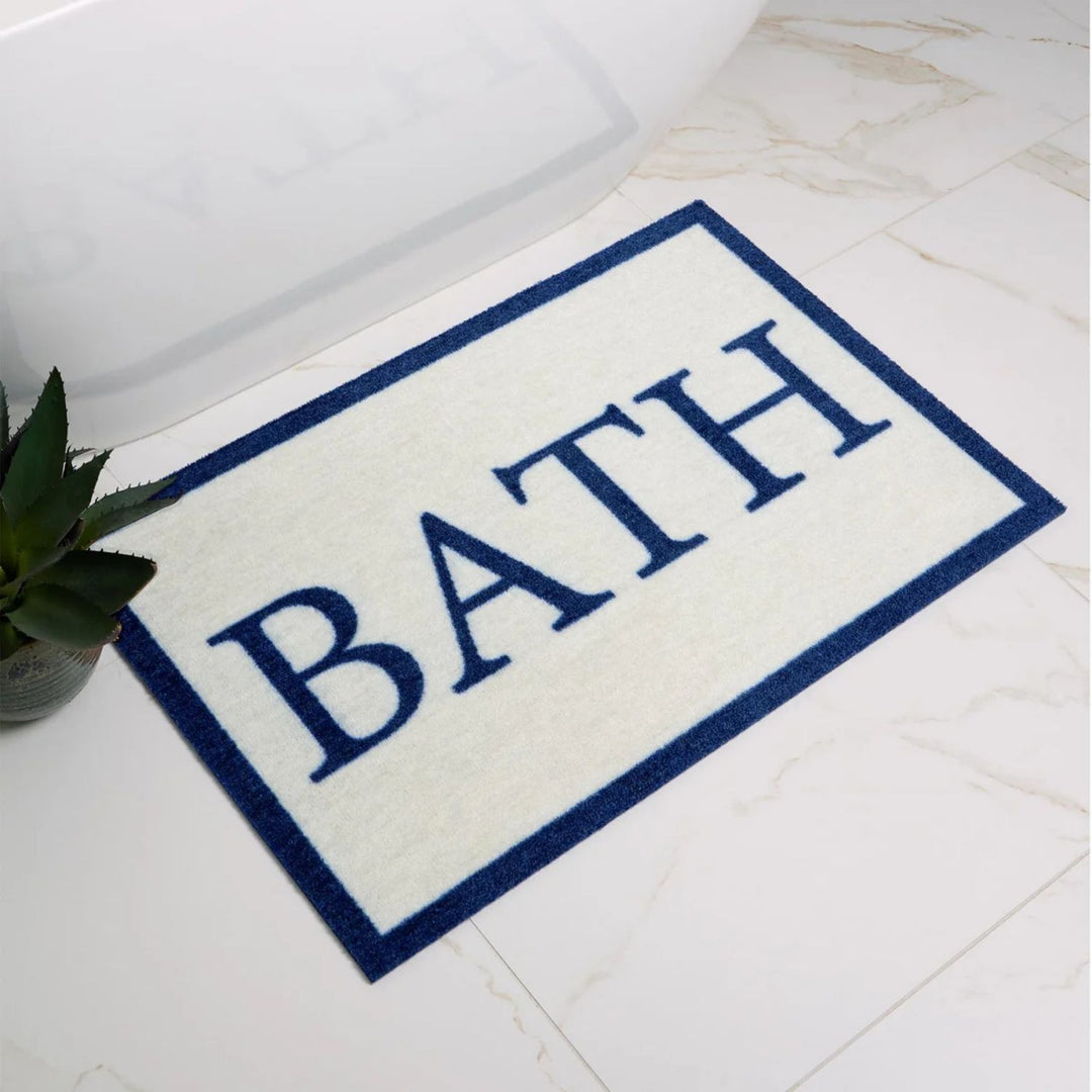 Bath mat with 'BATH' text on a bathroom floor