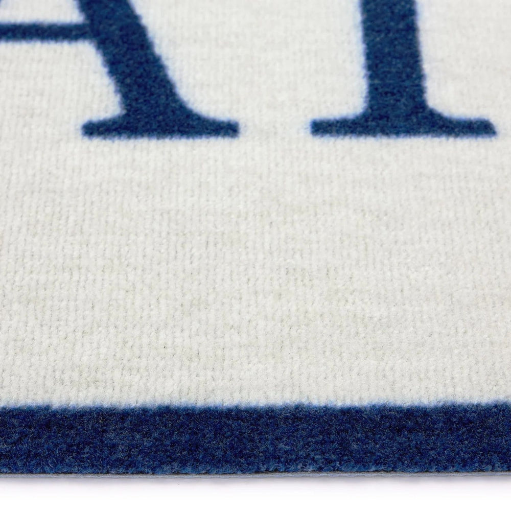Close-up of a white fabric with blue lettering and border
