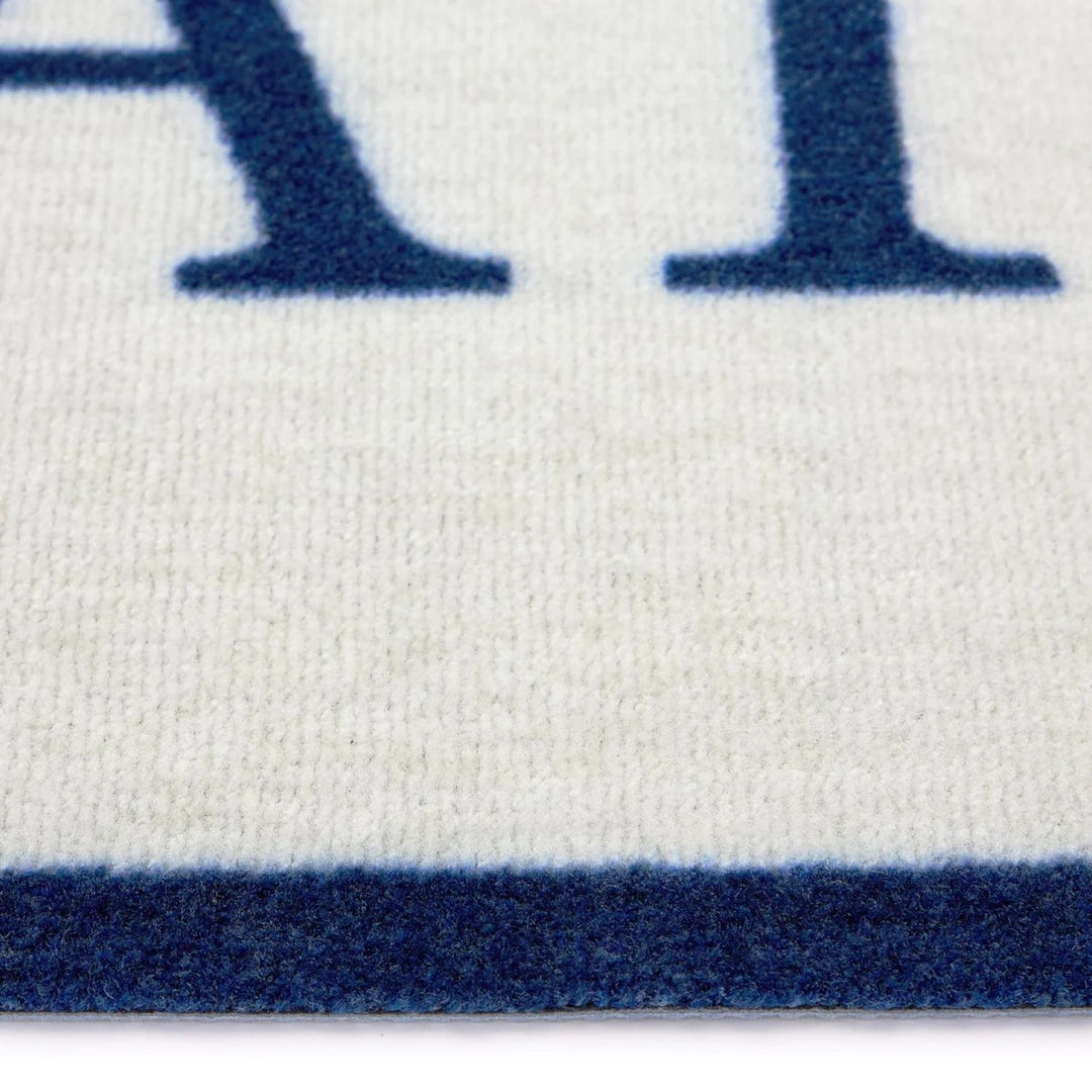 Close-up of a white fabric with blue lettering and border