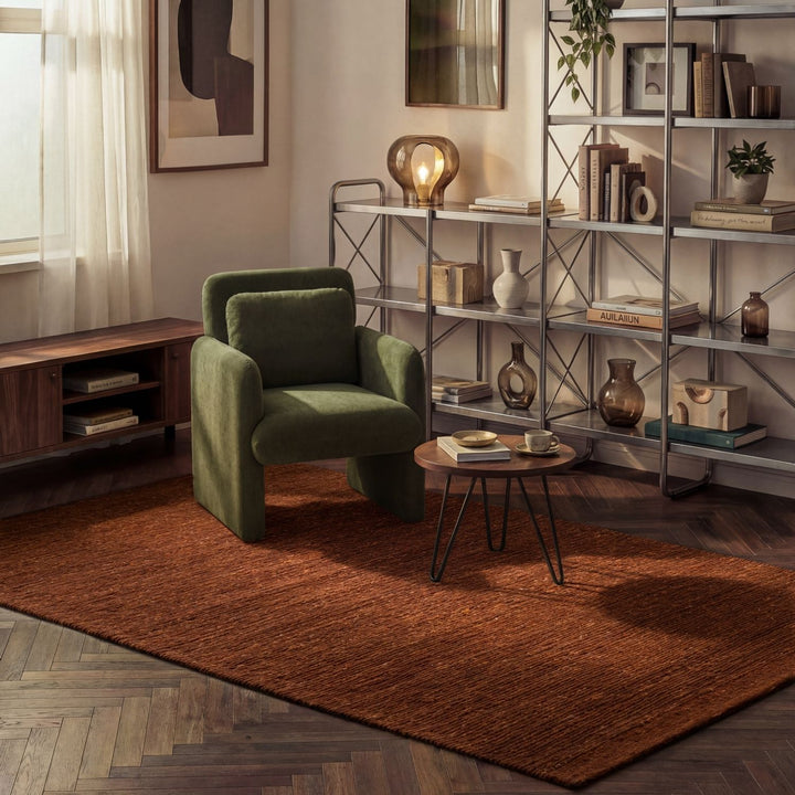 Modern living room with a green armchair, wooden coffee table, and metal shelving unit.